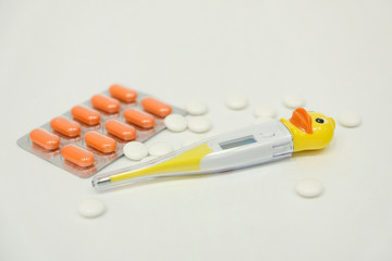 Pharmacy background on a white table. Tablets on a white background. Pills. Medicine and healthy. Close up of capsules. Stethoscope on a white wooden background. Copy space for a text.