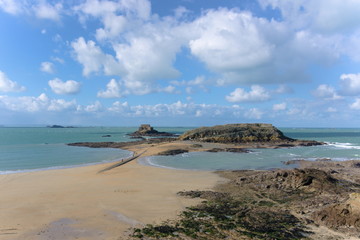 Ocean landscape in Saint-Malo France, blue green clouds sky medieval rock fortresses on the coast