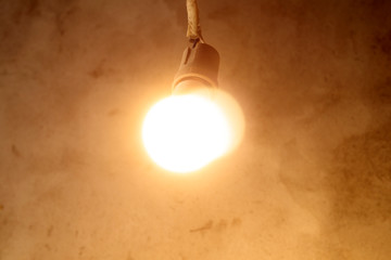 light bulb hanging on the wires. wall background of concrete. new construction concept