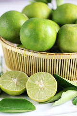 Fresh limes on white wooden background. Green limes.
