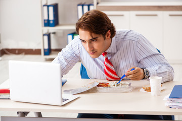 Man having meal at work during break