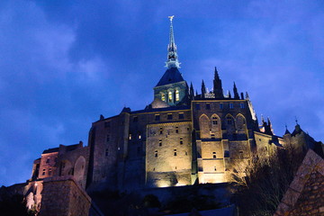 Fototapeta na wymiar Mont saint michel monastery at night lit from beneath sunset spooky gothic