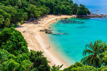 Tropical Laem Sing beach. Beautiful turquoise bay and people relaxing on beach. Paradise coast of Phuket, Thailand.