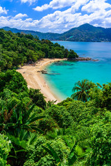Fototapeta na wymiar Tropical Laem Sing beach. Beautiful turquoise bay and people relaxing on beach. Paradise coast of Phuket, Thailand.