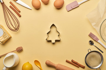 Fototapeta na wymiar top view of bakery ingredients and cooking utensils around tree shaped dough mold