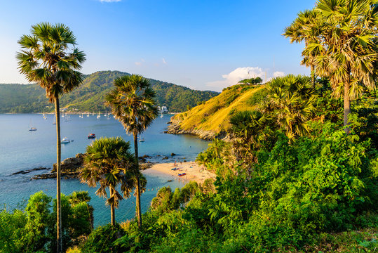 Yanui Beach is a paradise cove located between Nai Harn Beach and Promthep Cape in Phuket, Thailand. On a sunny summer day at sunset.