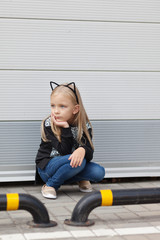 Fototapeta na wymiar Little girl wearing cat ears
