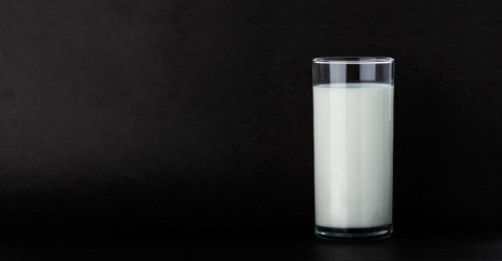 Glass of milk isolated on black background with copy space