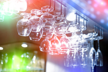 Empty  glasses hanging above the bar in the restaurant.