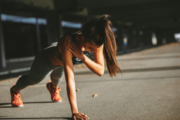 Young woman doing plank exercise