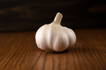 Garlic bulb on the wooden vintage background