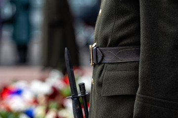 Abstract background on military theme. A soldier with a weapon in guard, close-up - image