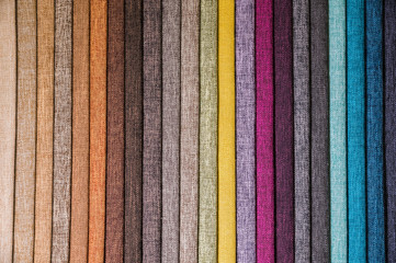 Colorful and bright fabric samples of furniture and clothing upholstery. Close-up of a palette of...