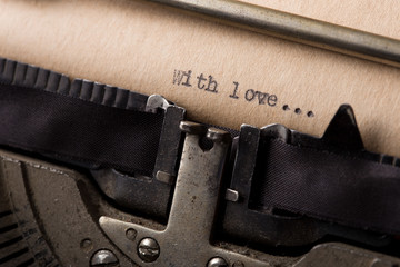 With love - text message on the typewriter close-up