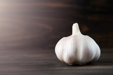 Garlic bulb on the wooden vintage background
