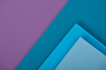 top view of purple and blue paper sheets with copy space