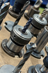 Obraz premium Metal drills, cutters, cones. Metal cutting tools installed in clamping chucks.