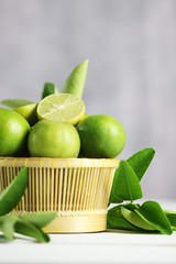 Fresh limes on white wooden background. Green limes.