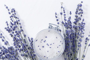 Lavender flowers and jar with sea salt. Spa background with copy space. Selective focus.