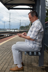 the man at the station looking at the phone