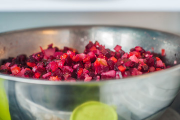 Vinaigrette salad in an iron bowl is stored on the shelf of the refrigerator
