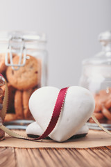 Gingerbread cookies, candies, cakes, sweets in jars on wooden table