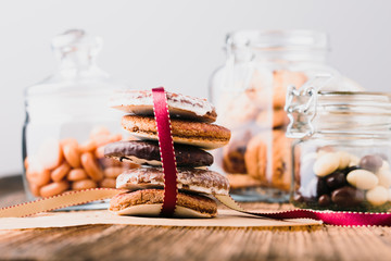Gingerbread cookies, candies, sweets, dessert in jars on wooden table