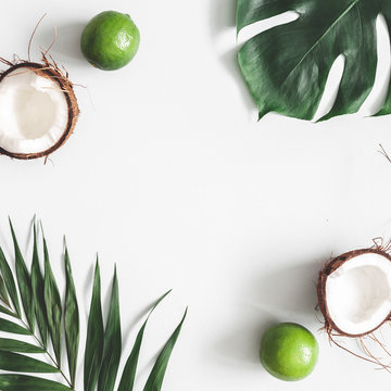 Summer composition. Tropical palm leaves, fruits on pastel gray background. Summer concept. Flat lay, top view, copy space, square