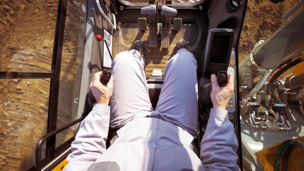 The driver view, control panel of a modern bulldozer or excavator or Loader, a man in Heavy...