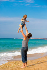 Father and daughter playing on the beach