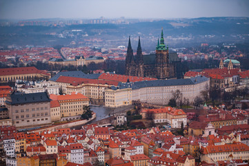 Fototapeta premium View on the red roofs of Mala Strana and St. Vitus Cathedral in Prague. Overcast weather