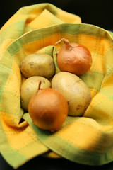 Vegetables onions and potatoes in beautiful black background
