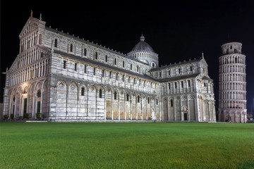 Fototapeta na wymiar Night scene with Leaning Tower of Pisa and 11th century Roman Catholic cathedral, Italy. Historic Piazza dei Miracoli, UNESCO World Heritage Site