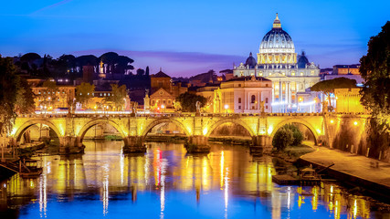 Fototapeta na wymiar The dome of Saint Peters Basilica and Vatican City at dusk. Sant'Angelo Bridge over the Tiber River. Rome, Italy