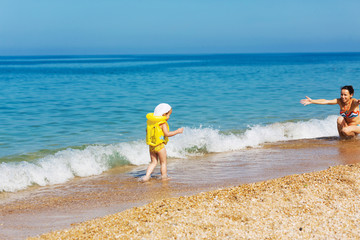 Mother and daughter playing on the beach