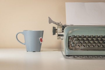 old typewriter and cup