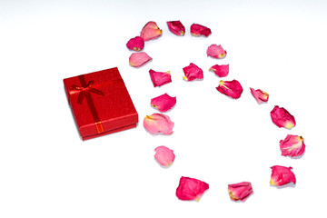 Red gift box, the figure is 8 out of rose petals. Selective focus. Concept of International women's day and Valentine's Day.