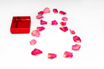 Red gift box, the figure is 8 out of rose petals. Selective focus. Concept of International women's day and Valentine's Day.