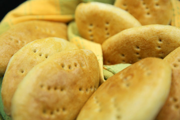Fresh baked fragrant wheat bread beautifully spread out on the background.