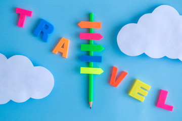 Colorful letters travel abstract with sign and paper clouds.