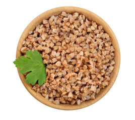 Buckwheat porridge in wooden bowl isolated on white background. Top view