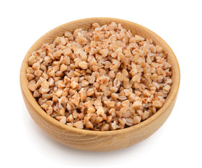 Buckwheat porridge in wooden bowl isolated on white background