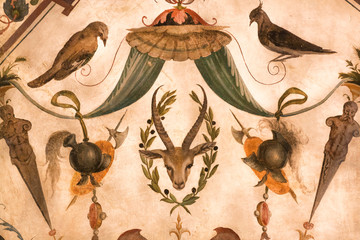 Roe deer and birds on fragment of fresco inside 14th century Palazzo Vecchio, Florence. Medieval art of Italy
