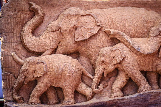 Beautiful Wood carving of elephant family. Antique Art Handmade Furniture which Carvings Elephant Family in The Wood. Elephant wooden crafted for sale in the local market at Northern Thailand.