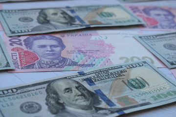 American one hundred dollars banknote and ukrainian hryvnas