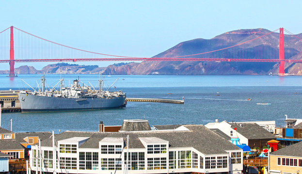 Iconic San Francisco Golden Gate Bridge, Famous Pier 39 tourist district in the foreground.
