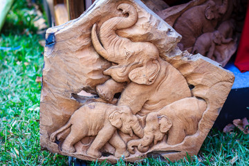 Beautiful Wood carving of elephant family. Antique Art Handmade Furniture which Carvings Elephant Family in The Wood. Elephant wooden crafted for sale in the local market at Northern Thailand.