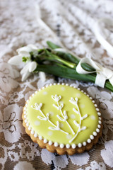 Spring composition of a bouquet of snowdrops and painted gingerbread. Rustic style.