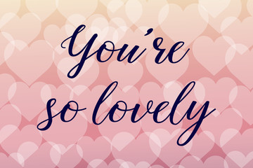 You’re so lovely. Calligraphy saying. Bokeh background