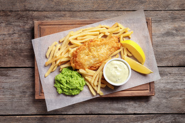 British traditional fish and potato chips on wooden background, top view